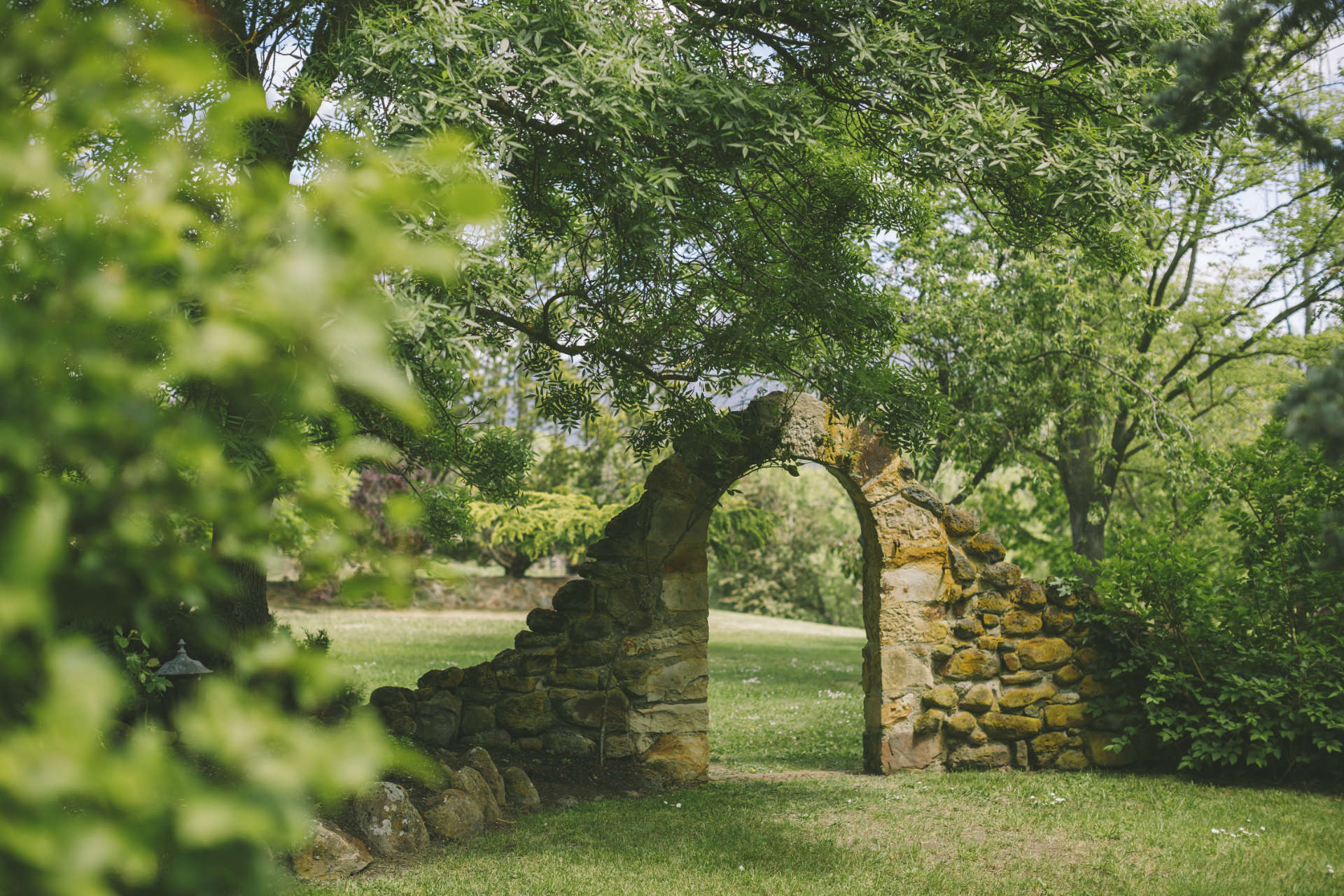 Historic stone wedding arbour nestled in private gardens at Stonefield Estate wedding venue near Hobart, Tasmania