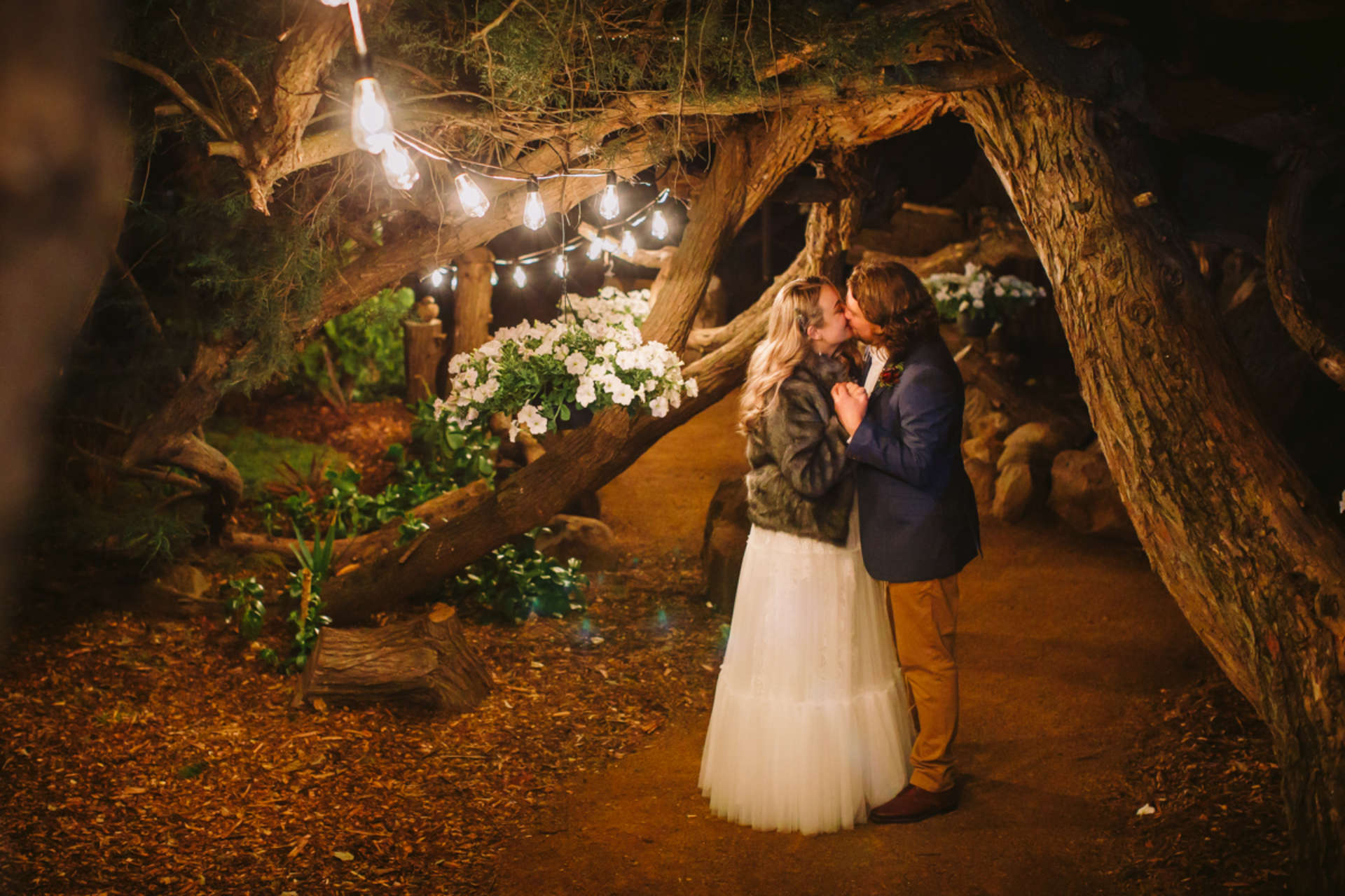 Charming wedding photo under festoon lights amongst the trees in the private garden at Stonefield Estate, near Hobart Tasmania